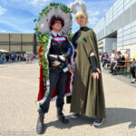 Two cosplayers present their costumes at DoKomi.