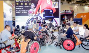 Visitor group in wheelchairs at REHACARE CHINA